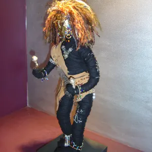 Dana Biddle — Shaman. Fabric wrapped wire armature embellished with glass seed beads and African trade beads, with a hand made copper mask and yarn headdress. 35cm tall. Sold, private collection.